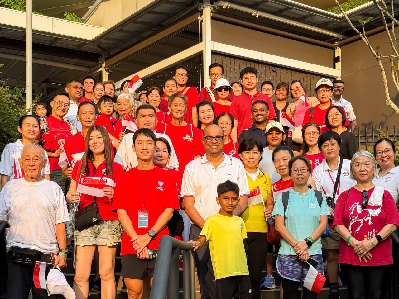 Steps of Harmony participants posing with Singapore flags