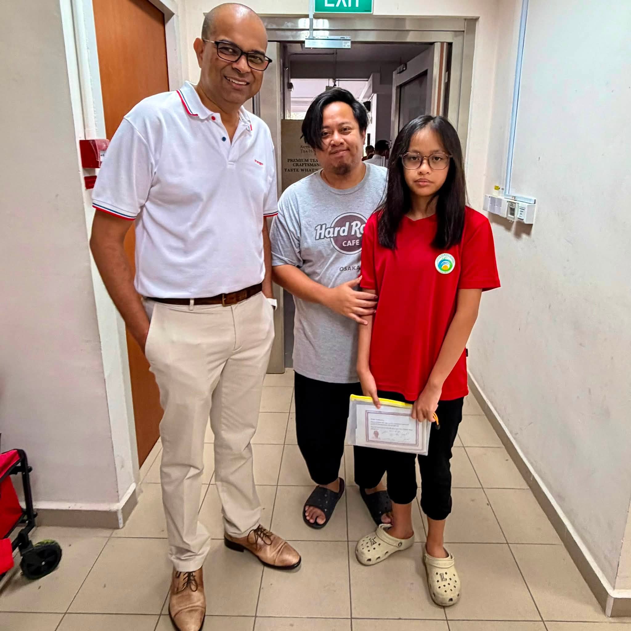 Student receiving certificate during Punggol Sunrise RN event