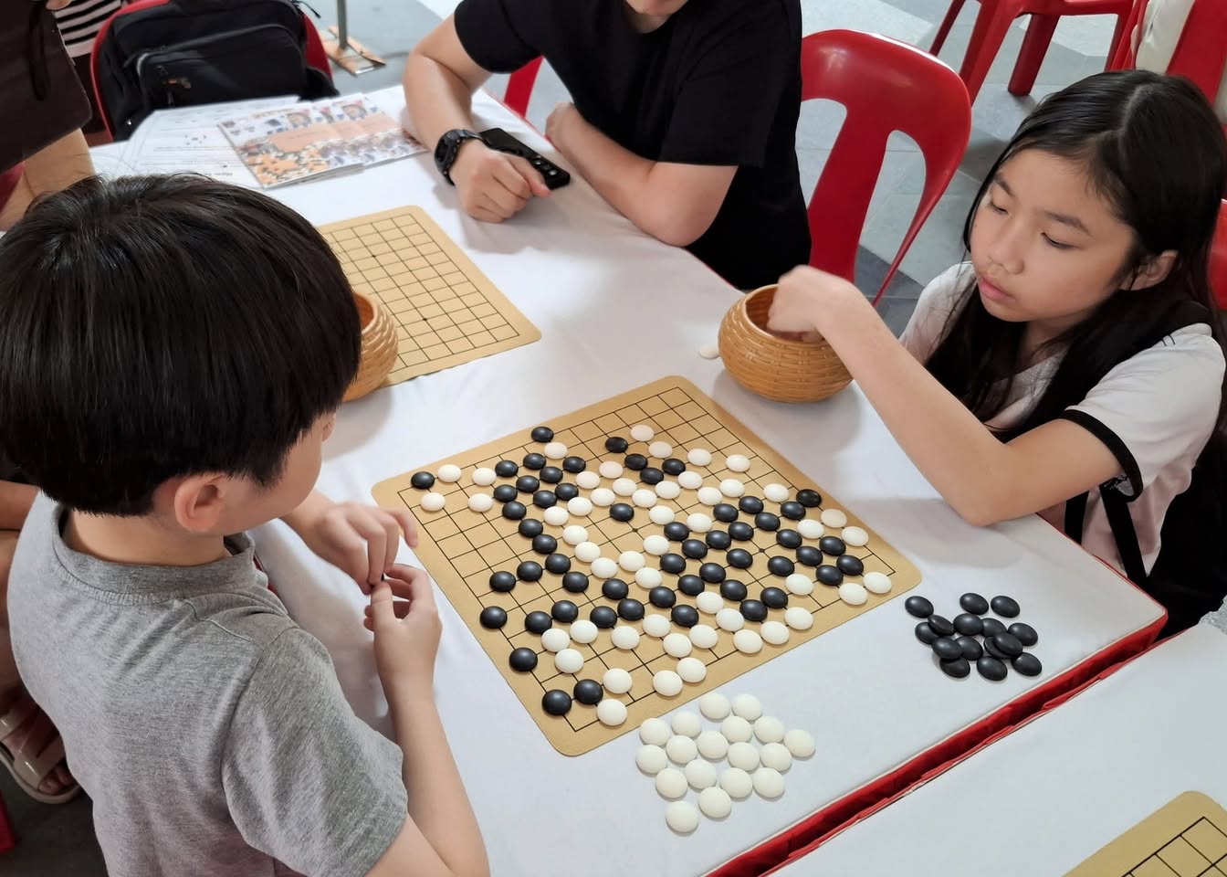 Various strategic board games like Chess, Xiangqi, and Weiqi laid out.