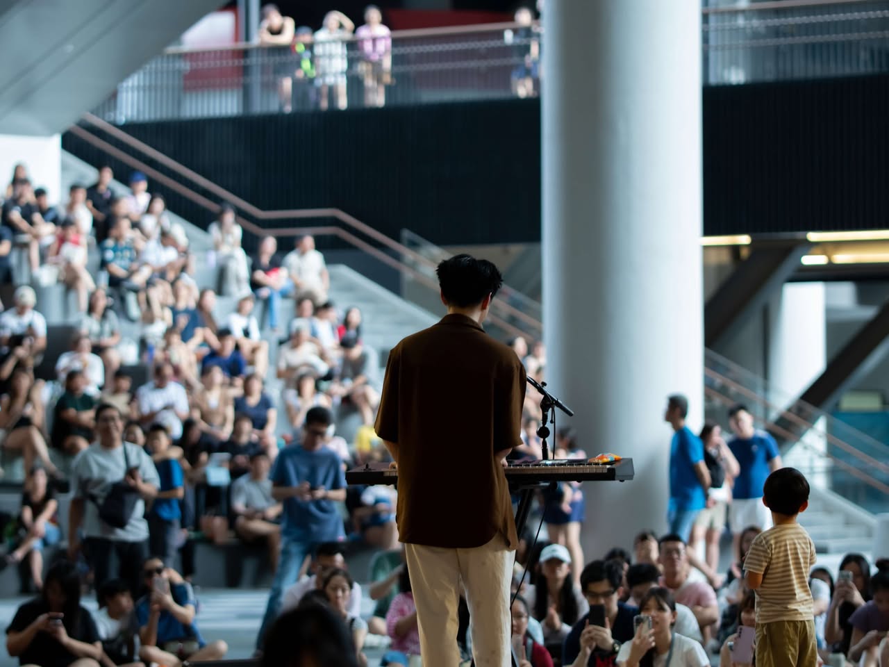 Singer Jeff Ng captivating a large audience during a singalong at Nexus.