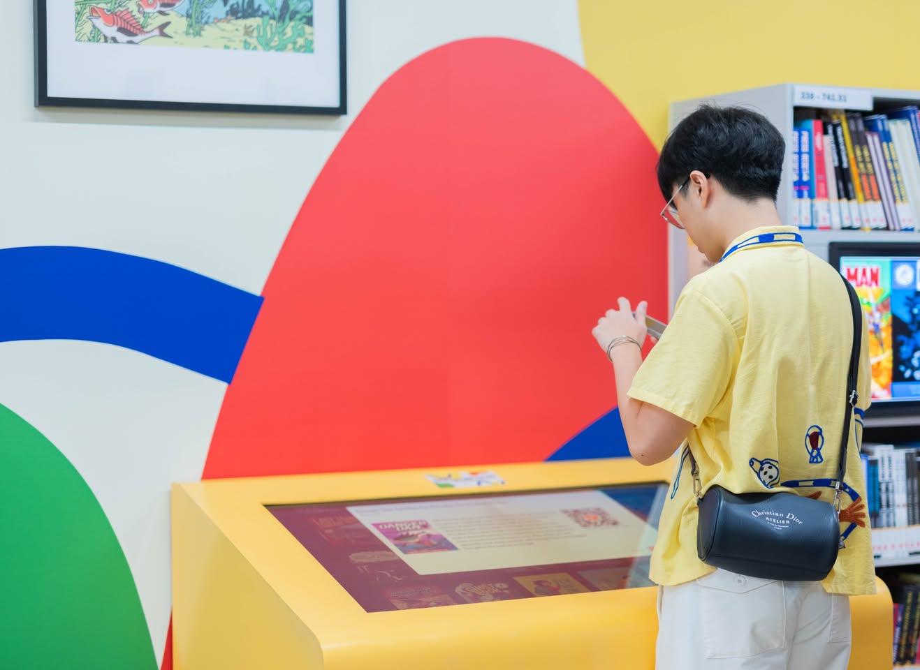 A person interacting with a self-service kiosk, showcasing the library's automated borrowing system.