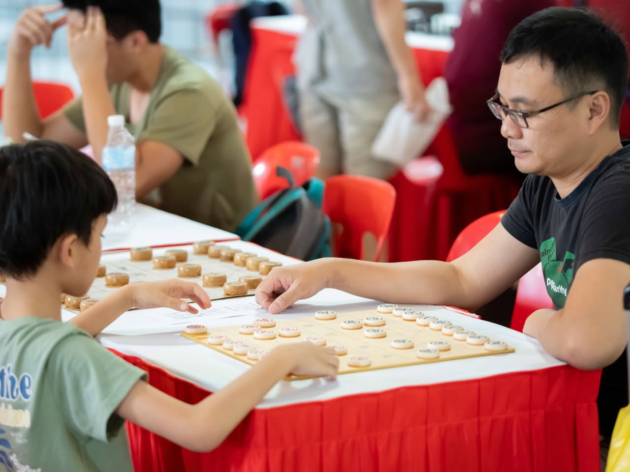 Participants proudly displaying their handcrafted paper kampongs.