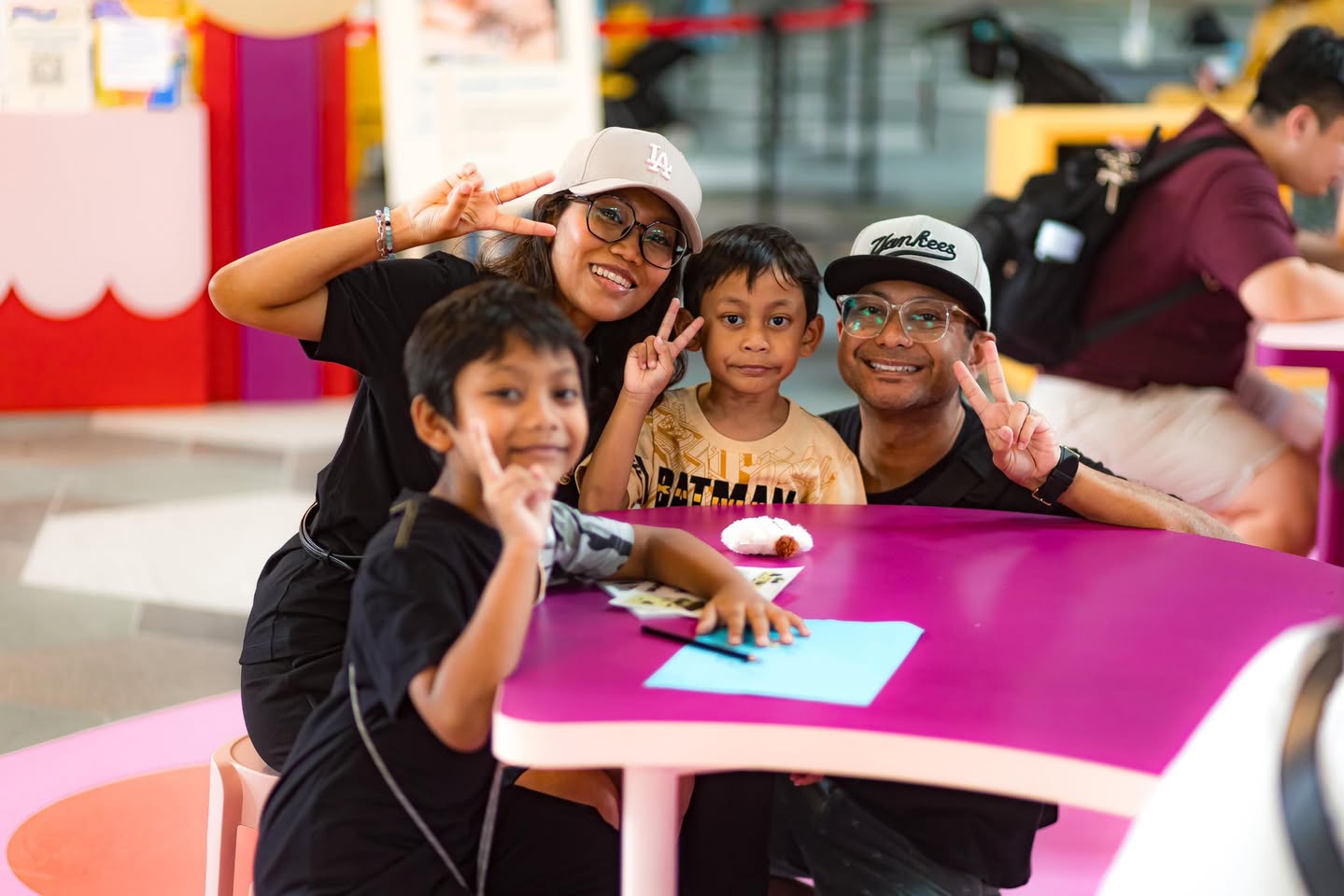 A family exploring a technology display at WonderLab.