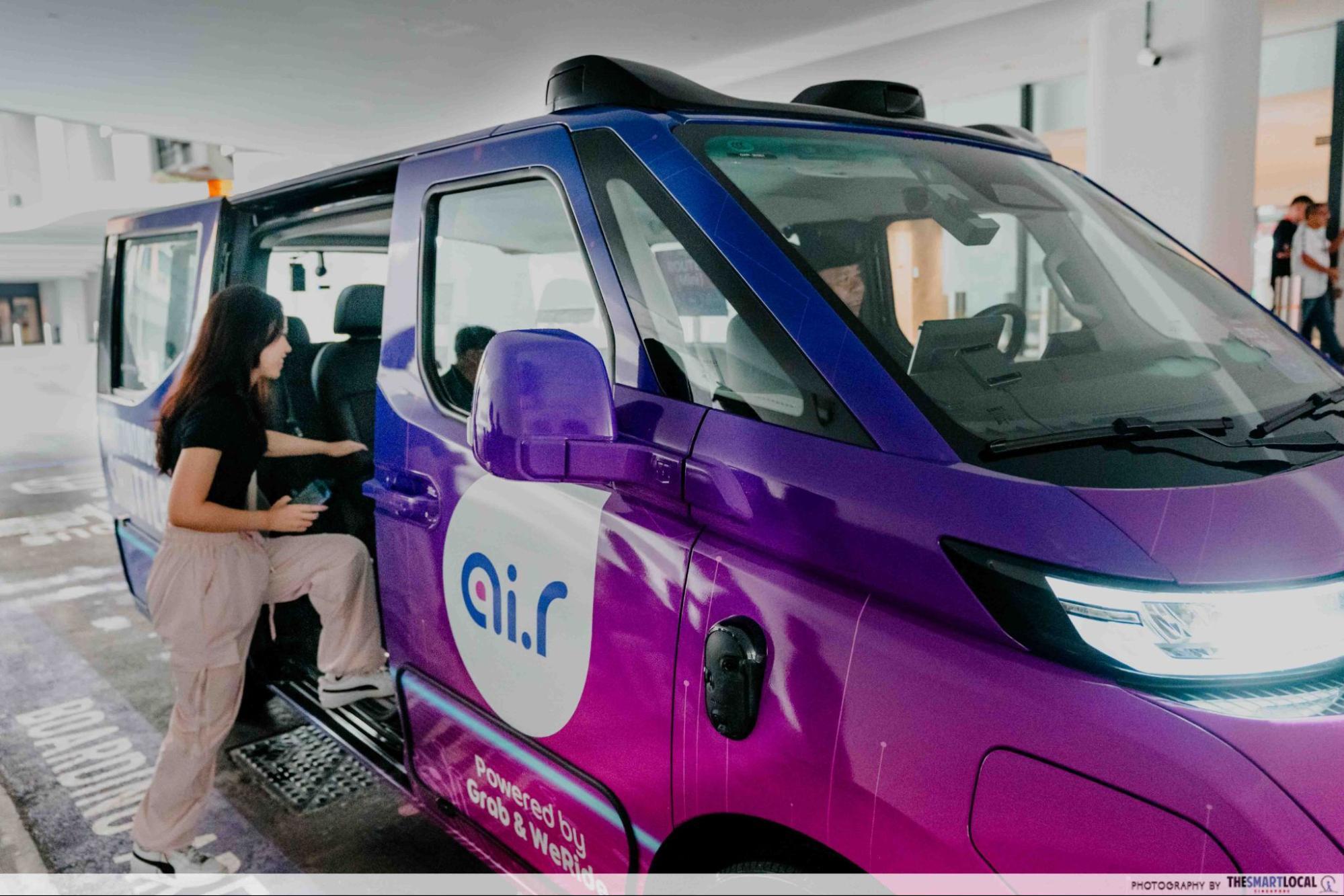 Passenger boarding a WeRide GXR autonomous shuttle at a Punggol pick-up point