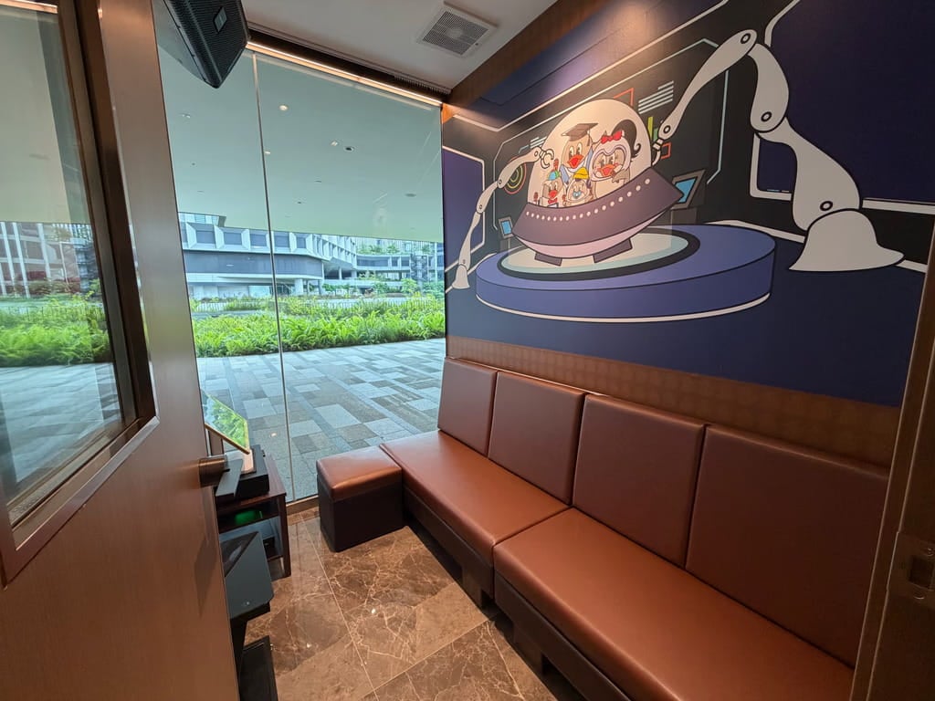 Teo Heng glass-window karaoke room looking onto Punggol Digital District
