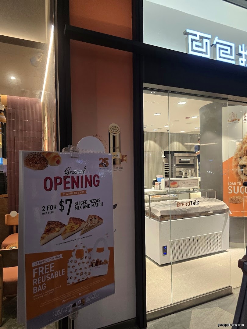 BreadTalk shop entrance with a promotional grand opening poster.