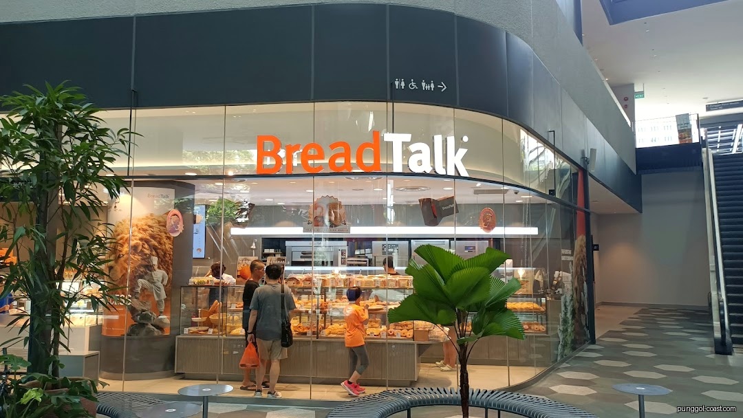 BreadTalk shop exterior with glass facade, displaying baked goods and customers.
