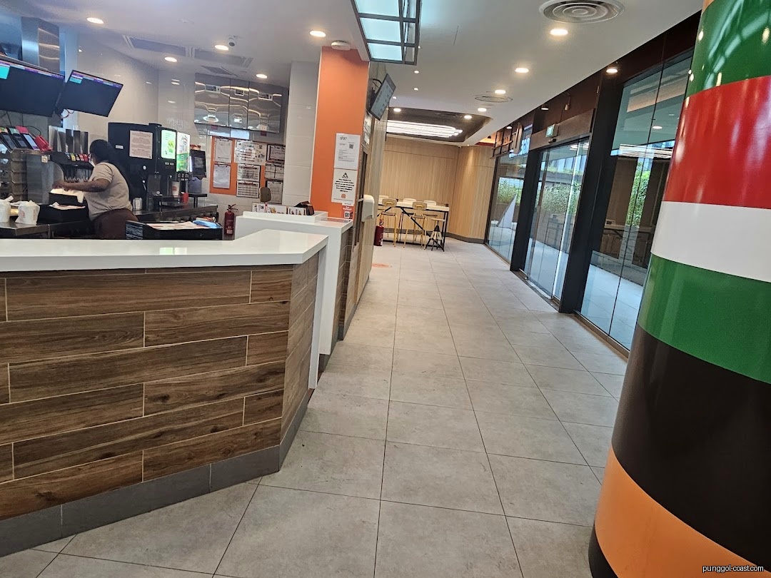 Inside a Burger King, showing the service counter, staff, and adjacent hallway.