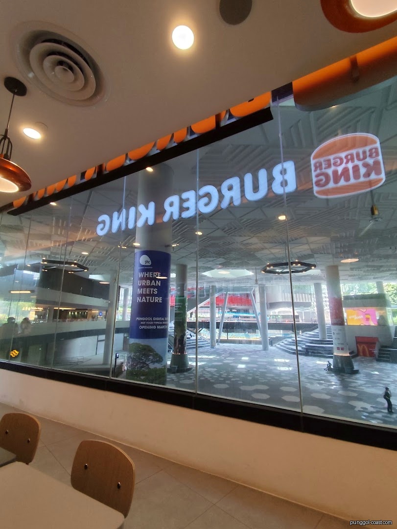 Interior view of Burger King looking out through glass window into mall.
