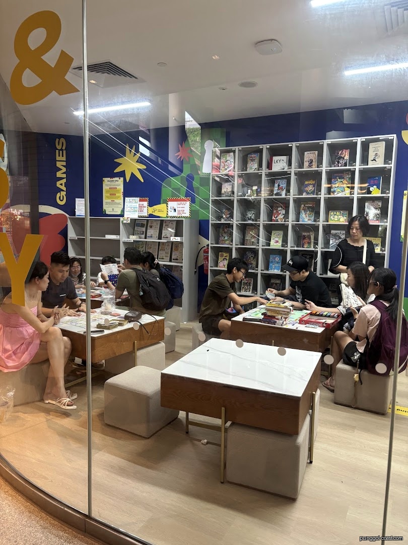 People playing games and reading inside a comics and games shop.