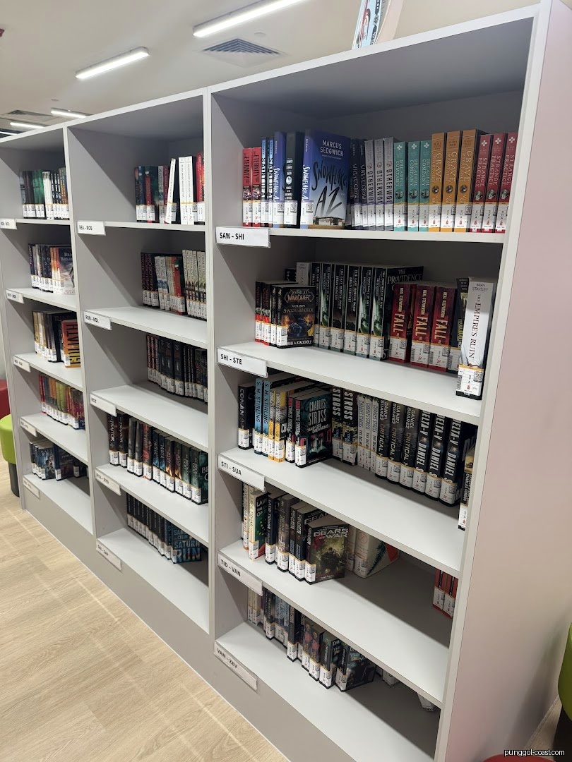 Interior view of a library or bookstore with shelves full of books.