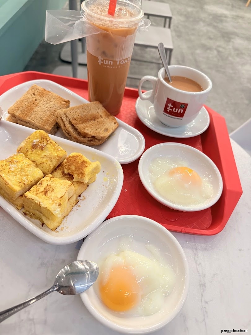 Breakfast set with toast, eggs, and drinks on a red tray.
