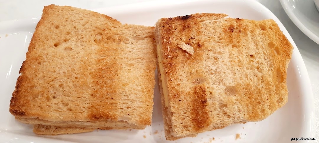 Two slices of toasted bread on a white plate.