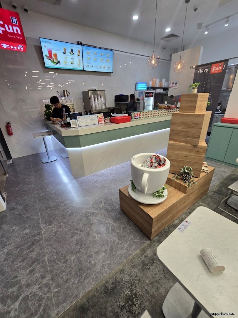 Modern shop interior with counter, staff, digital menus, and unique cup decor.