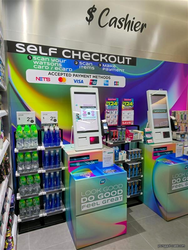 Interior view of Watsons store showing self-checkout kiosks and product displays.