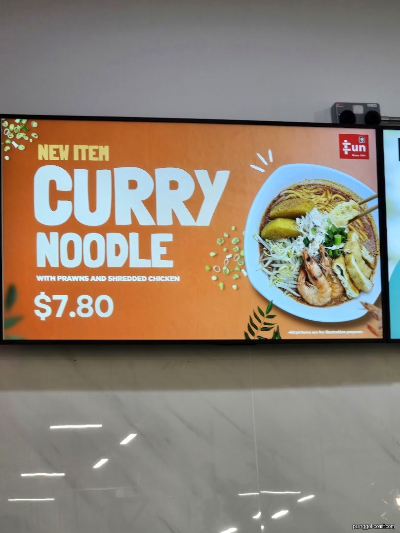 Digital menu board displays 'New Item Curry Noodle' with prawns and shredded chicken for $7.80.