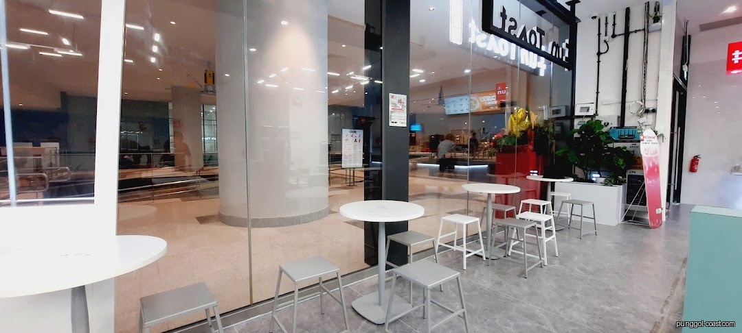 Exterior view of Fun Toast with outdoor seating and glass facade.