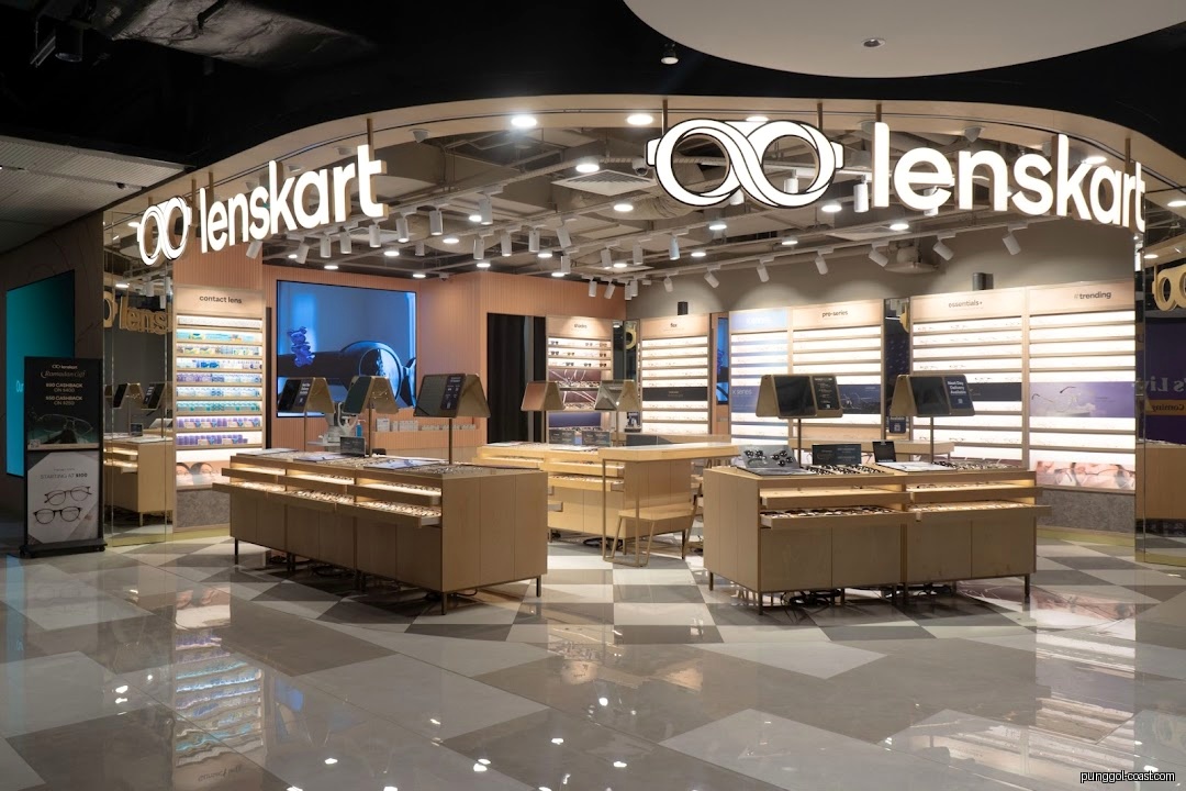 Interior view of a Lenskart eyewear store with display cases and products.