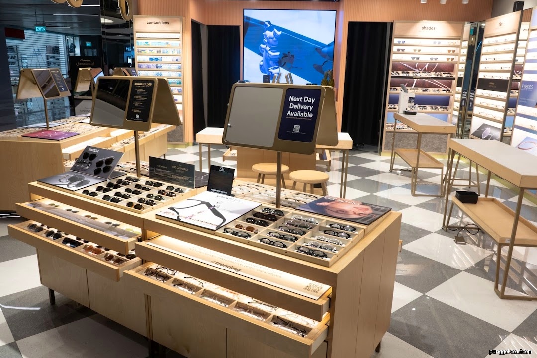 Interior of a Lenskart store with displays of eyeglasses and sunglasses.