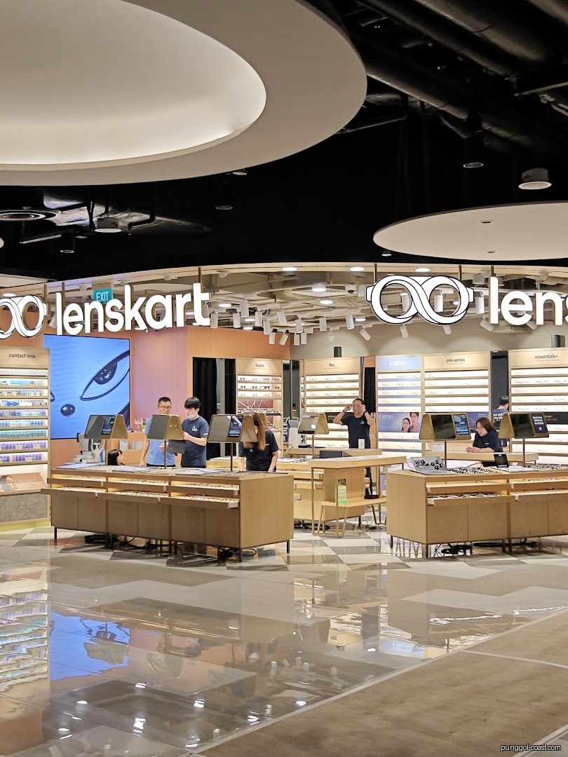 Interior view of Lenskart store with customers and eyeglasses displays.