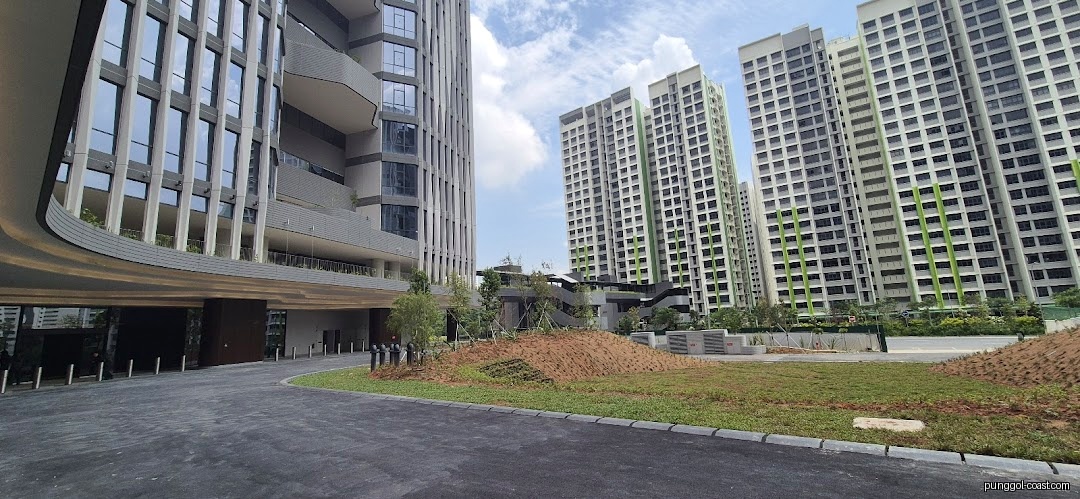 Modern buildings and landscaping with a driveway leading to an entrance.