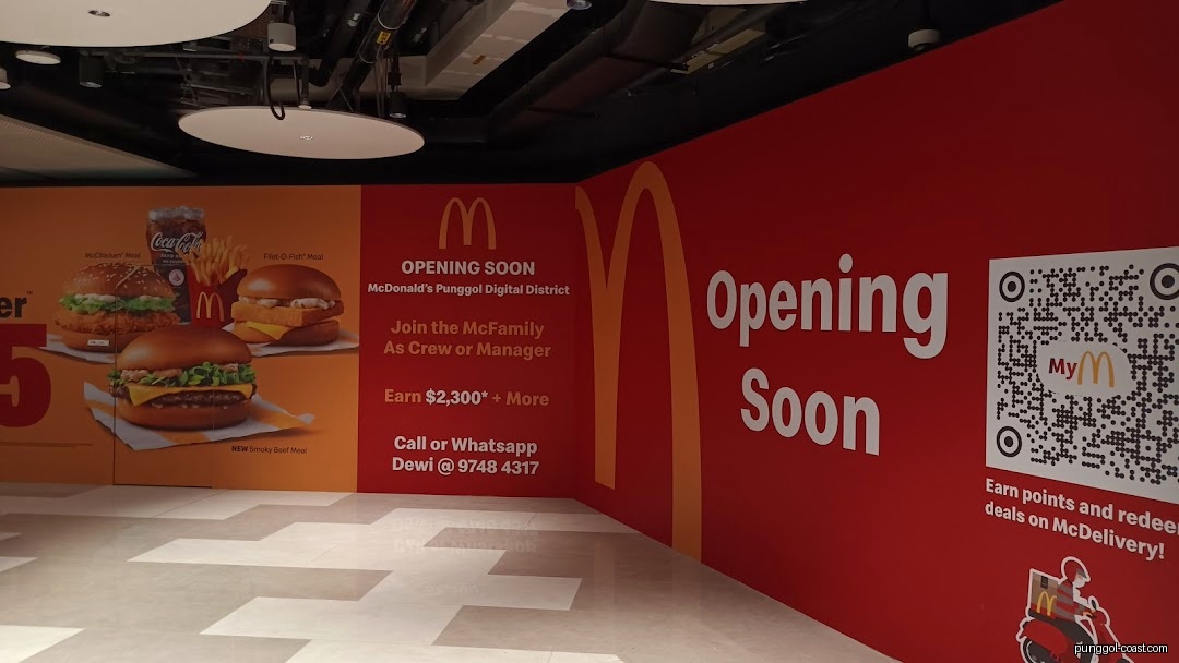 McDonald's 'Opening Soon' hoarding displays food, recruitment, and QR code.