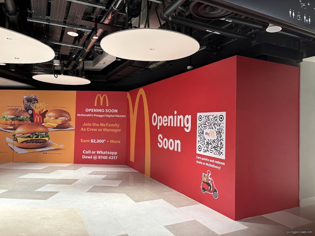 McDonald's 'Opening Soon' hoarding with food images and recruitment information.
