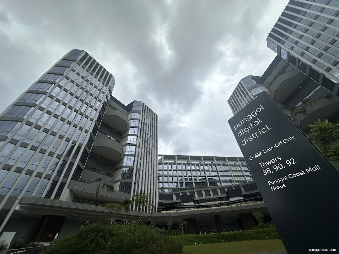 Modern buildings and a large directional sign for Punggol Digital District.