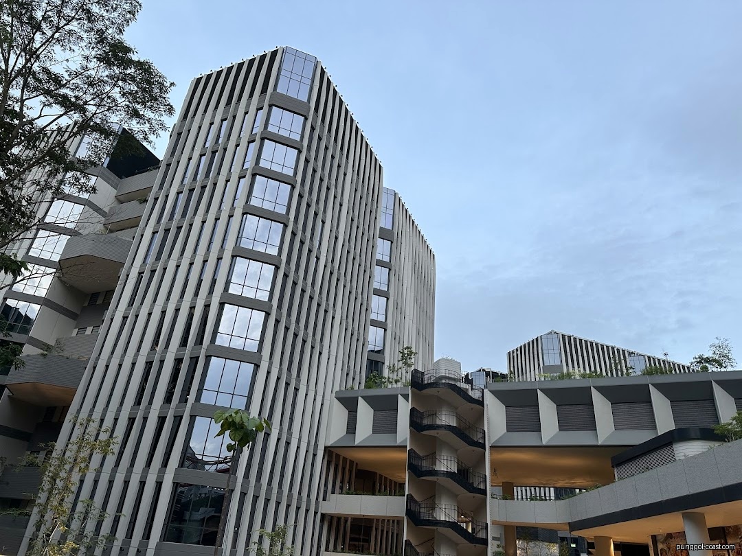 Exterior view of modern, multi-story buildings with glass windows and unique design.