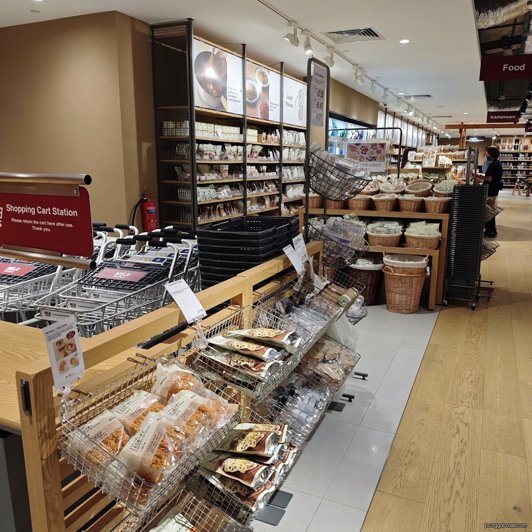 Interior view of a Muji store with shopping carts and product displays.
