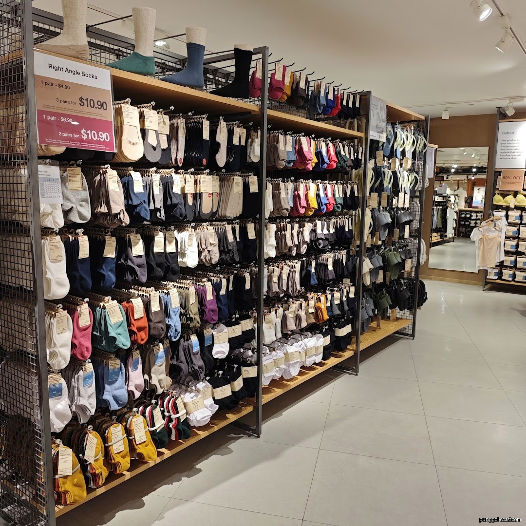 Interior shot of a retail store displaying numerous socks on shelves.