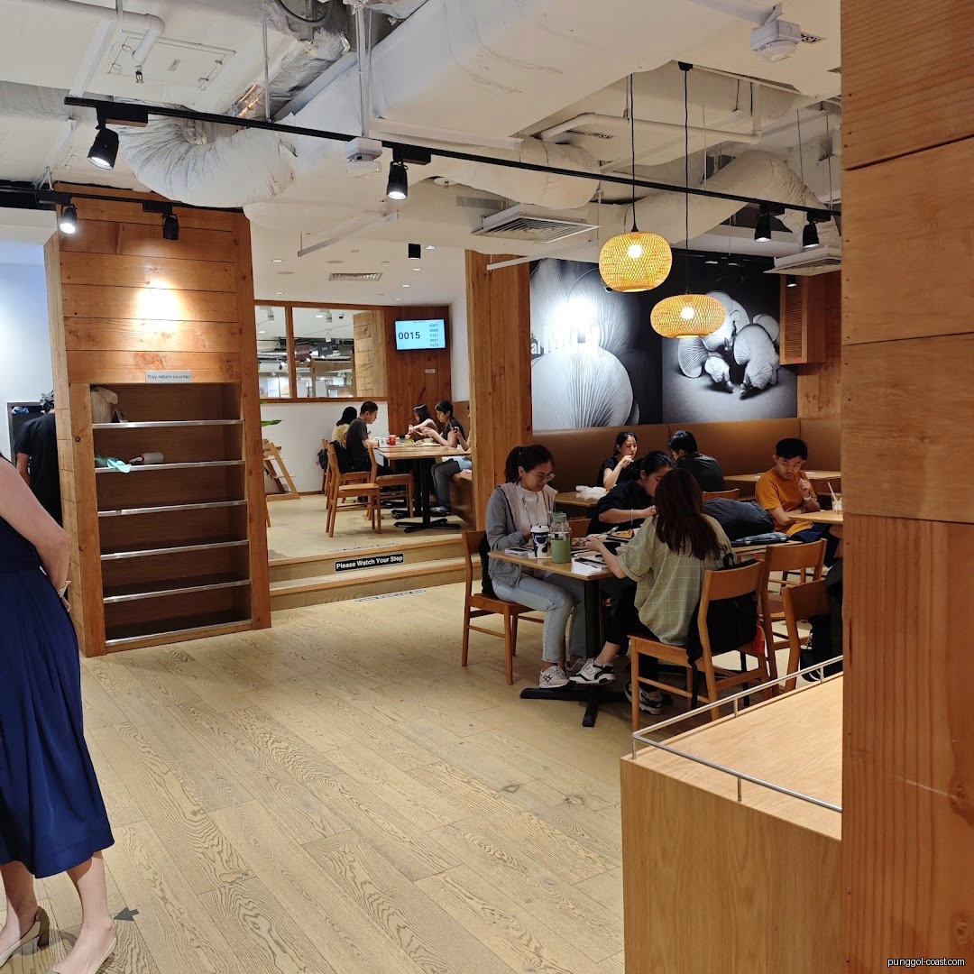 Interior view of a cafe with customers dining at tables.