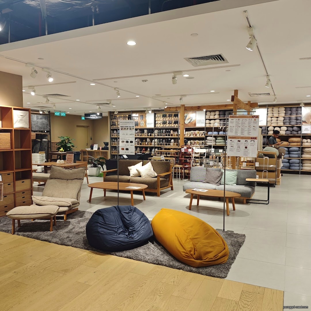 Interior view of a Muji store displaying furniture and home goods.
