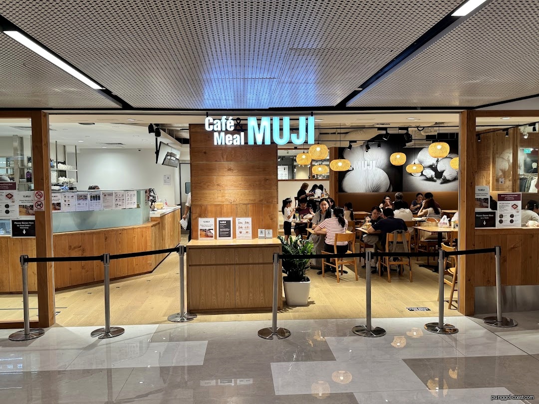 Entrance of Café & Meal MUJI with customers dining inside.