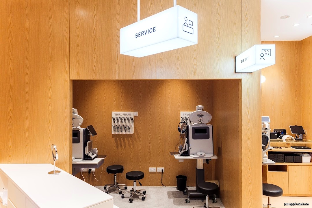 Interior of an optical shop with eye testing equipment and trial frames.