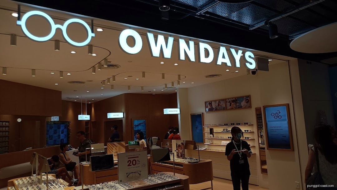 Interior view of OWNDAYS eyewear shop with customers and displays.