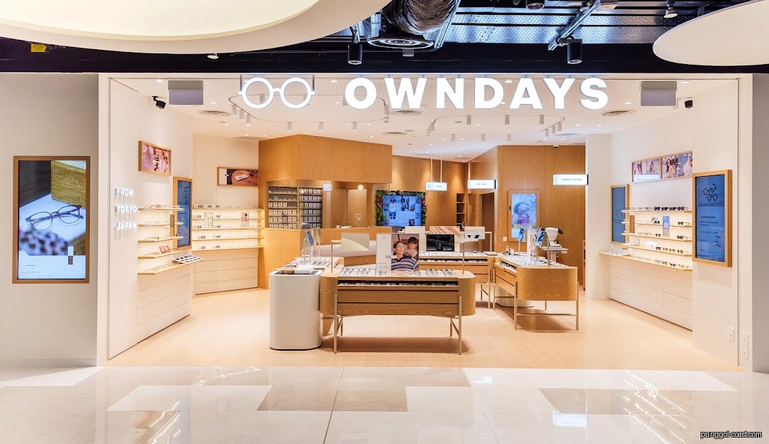 Front view of a bright OWNDAYS eyeglasses shop entrance with interior visible.