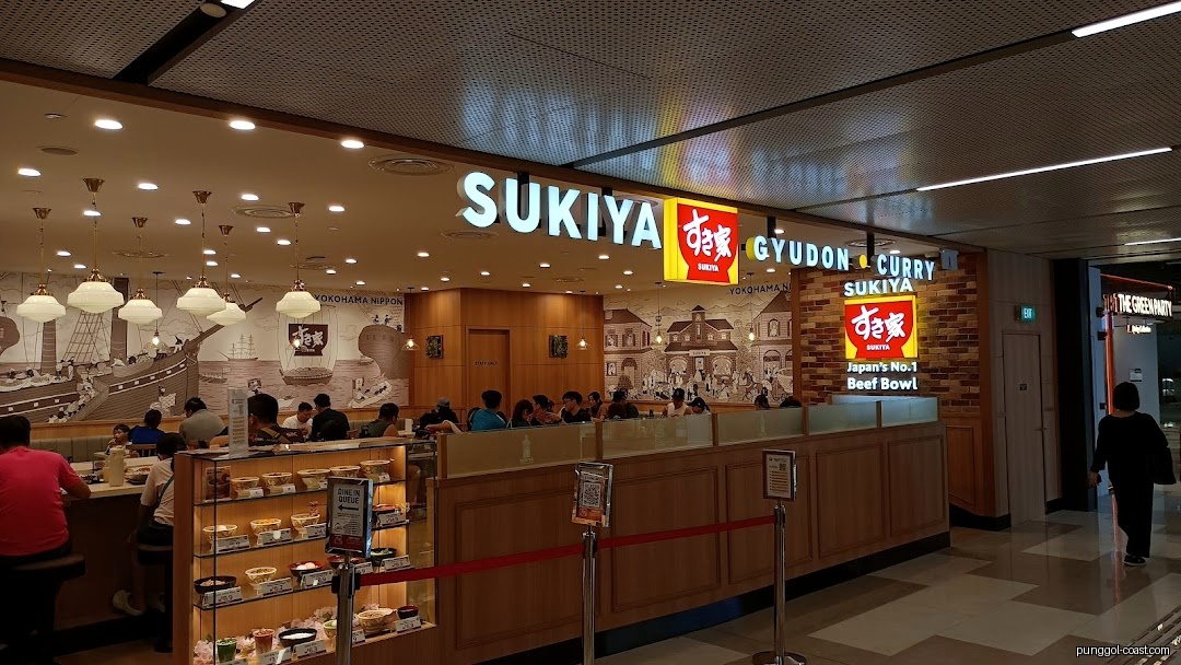 Sukiya restaurant entrance within a mall, showing signage, counter, and customers.
