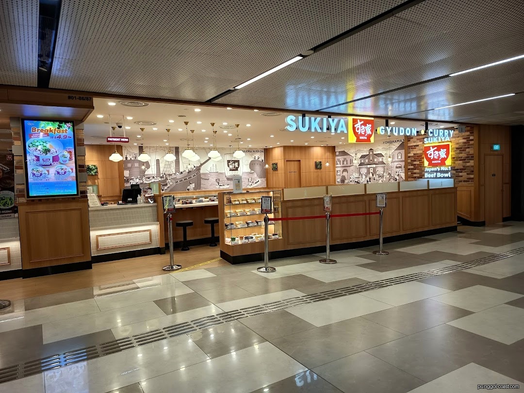 Exterior view of Sukiya restaurant with digital menu display.