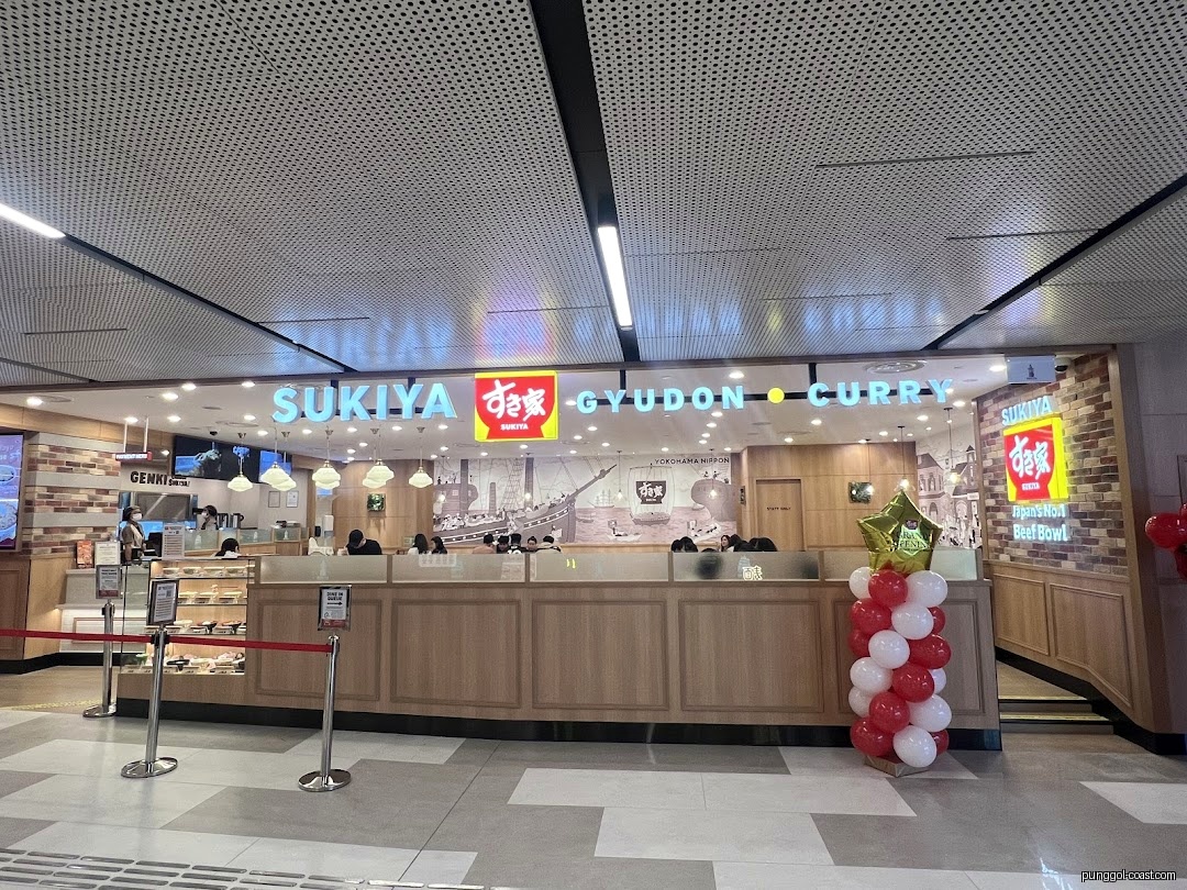 Exterior view of Sukiya restaurant entrance with prominent signage and balloons.