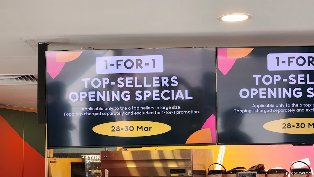 Digital screens display a 1-for-1 top-sellers opening special promotion.
