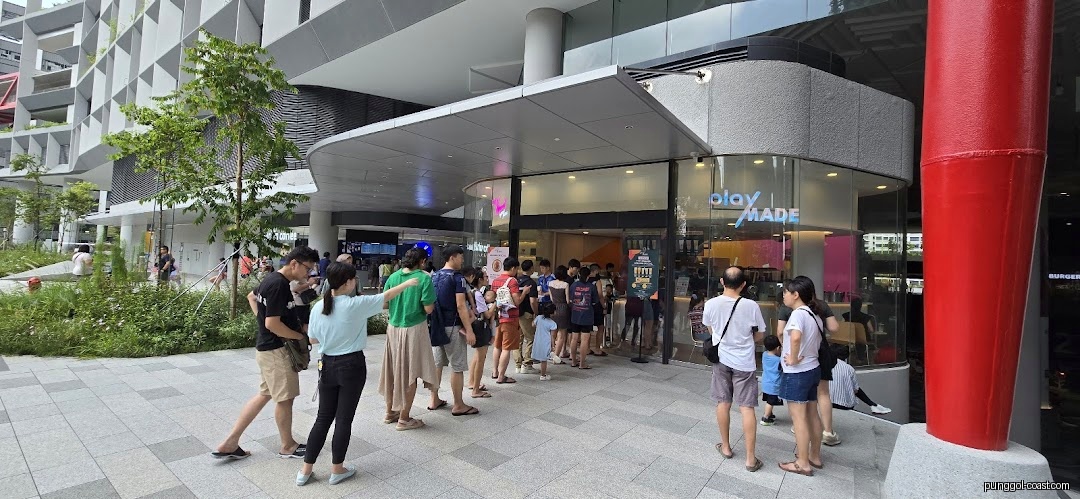 People queuing outside the entrance of "PlayMade" shop.