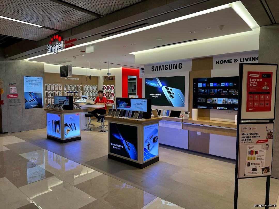 Interior view of a Singtel retail store with phone displays and a staff member.