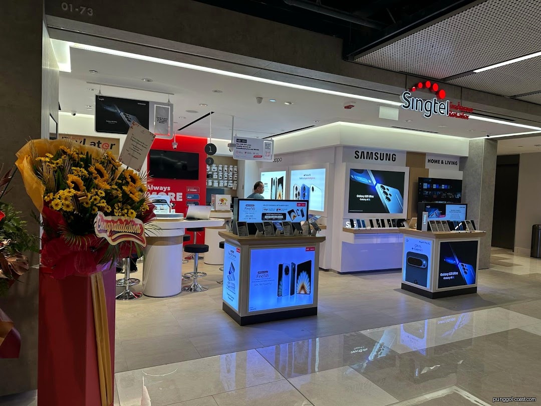 Interior view of a Singtel retail shop with product displays and flower stand.
