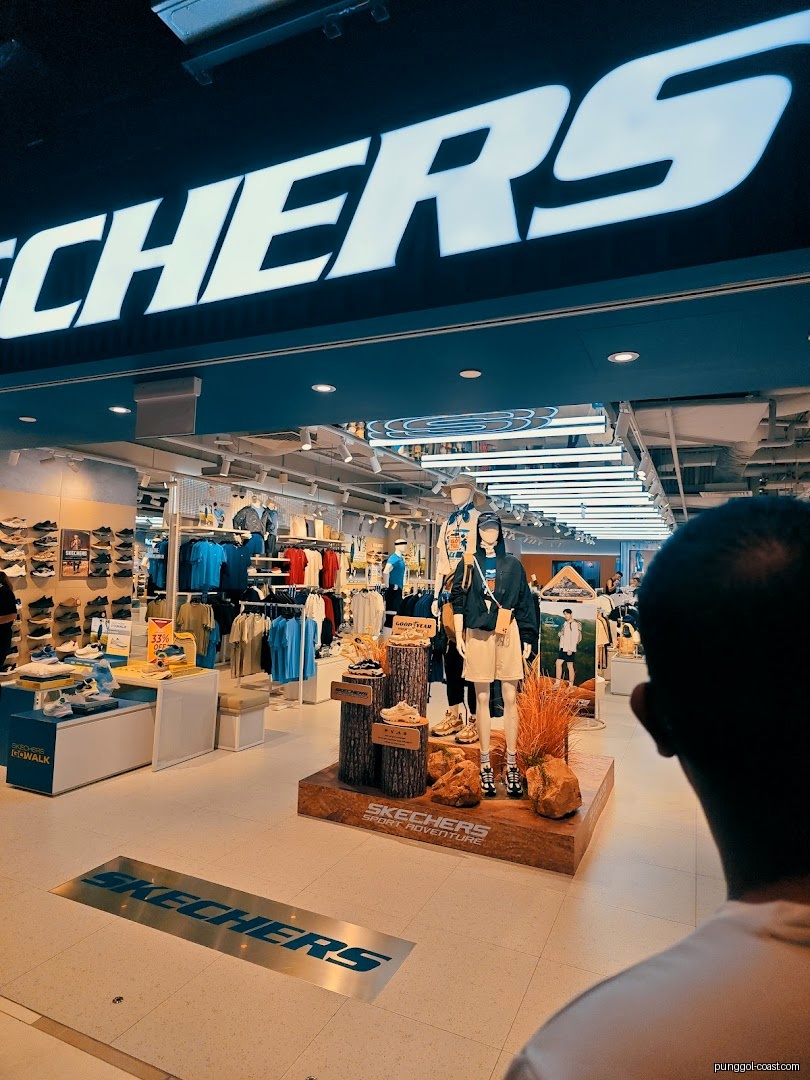 Interior view of a Skechers store with mannequins, shoes, and clothing displays.