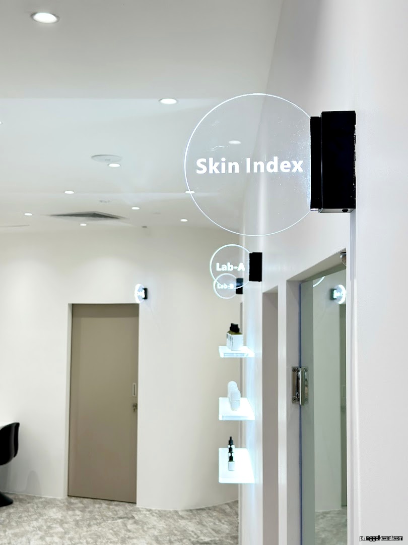 Modern interior of a skincare shop with product display shelves and signage.