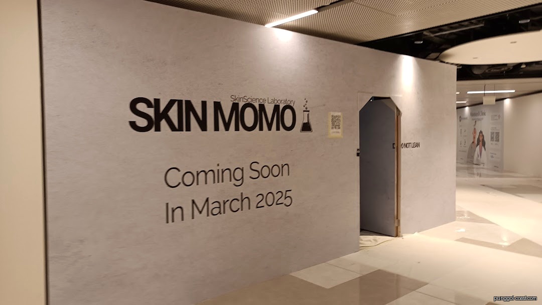 Temporary shop front hoarding for SKIN MOMO, announcing March 2025 opening.
