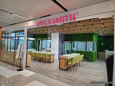 Exterior view of Specs Smith³ Punggol, an optical shop with green decor.