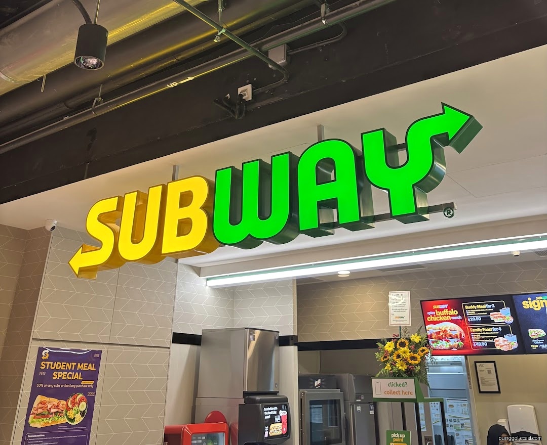 Interior view of Subway with prominent brand sign and counter area.