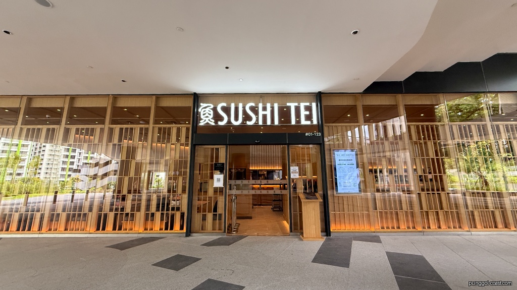 Exterior view of Sushi Tei restaurant with prominent signage and wooden facade.